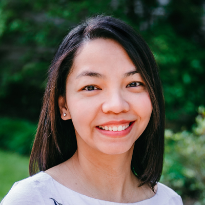 A woman with short brown smiling.