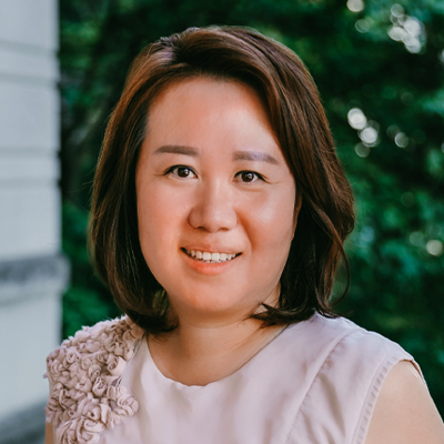 A woman with short brown hair smiling.